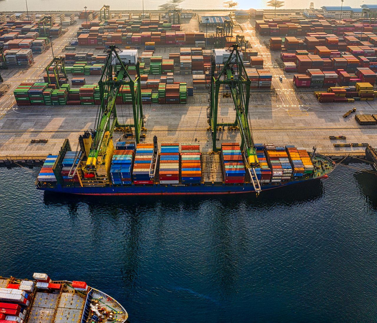 services-01 Aerial shot of colorful shipping containers at North Jakarta's bustling port, Indonesia.