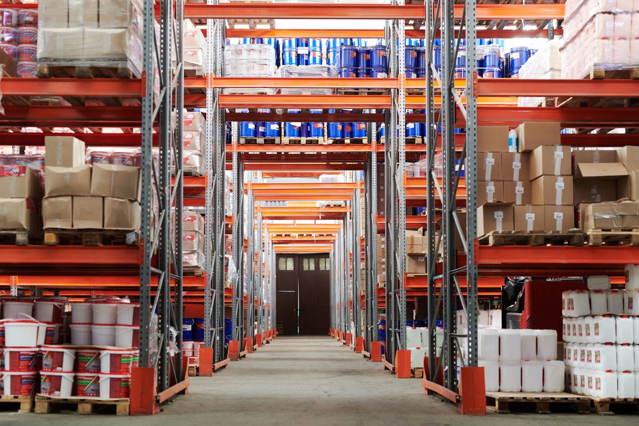 services-02 Wide angle view of a warehouse with stocked shelves and boxes.